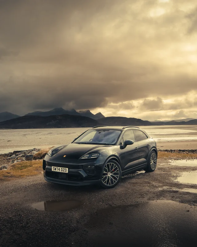 Porsche beside a loch at sunset